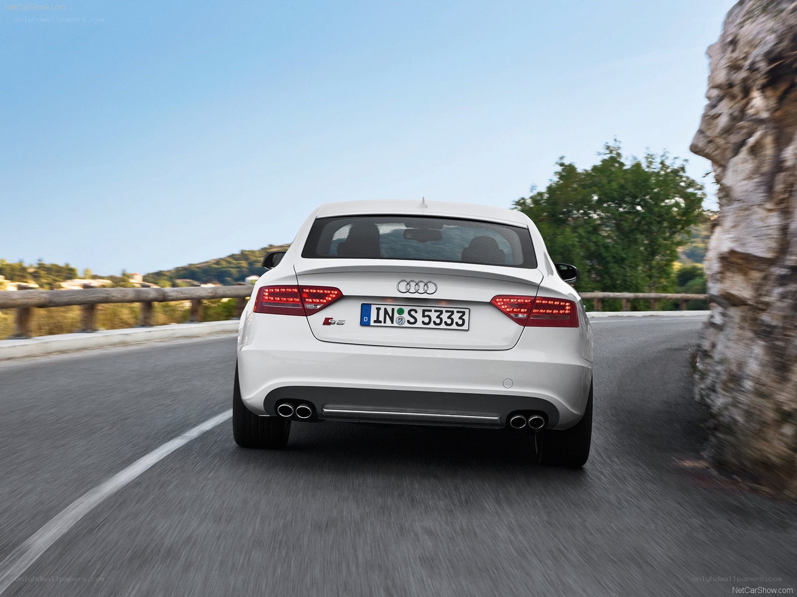white audi s5 driving on road