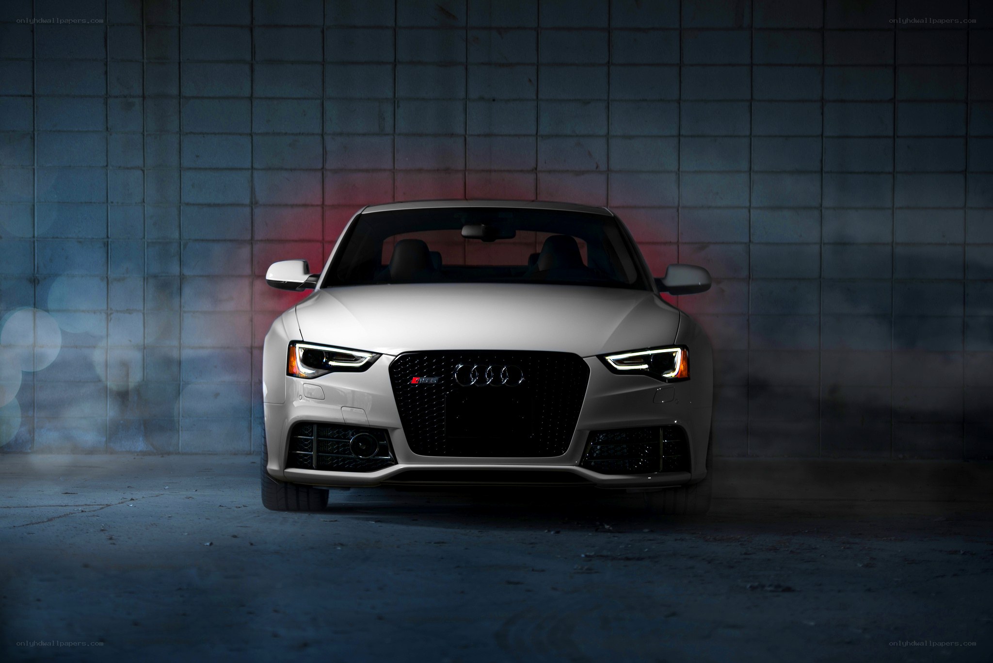 White Audi S5 in a dark garage