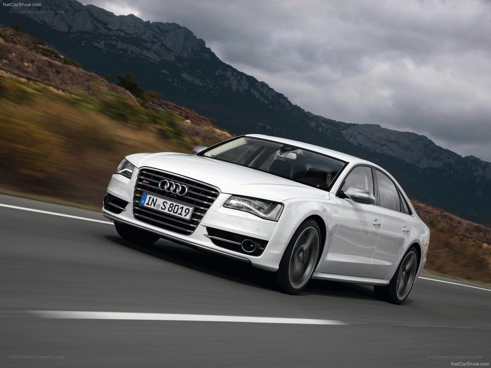 White Audi S8 driving on mountain road