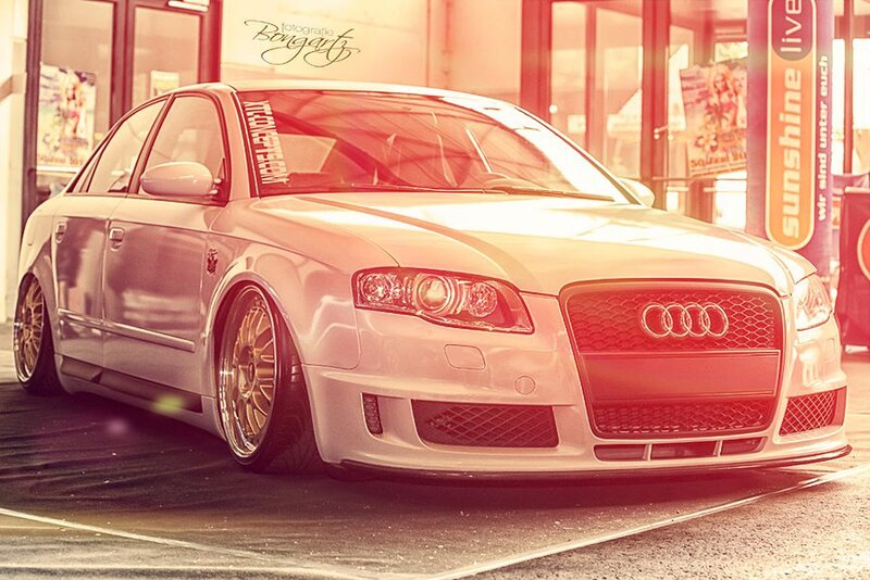 white audi sedan at gas station
