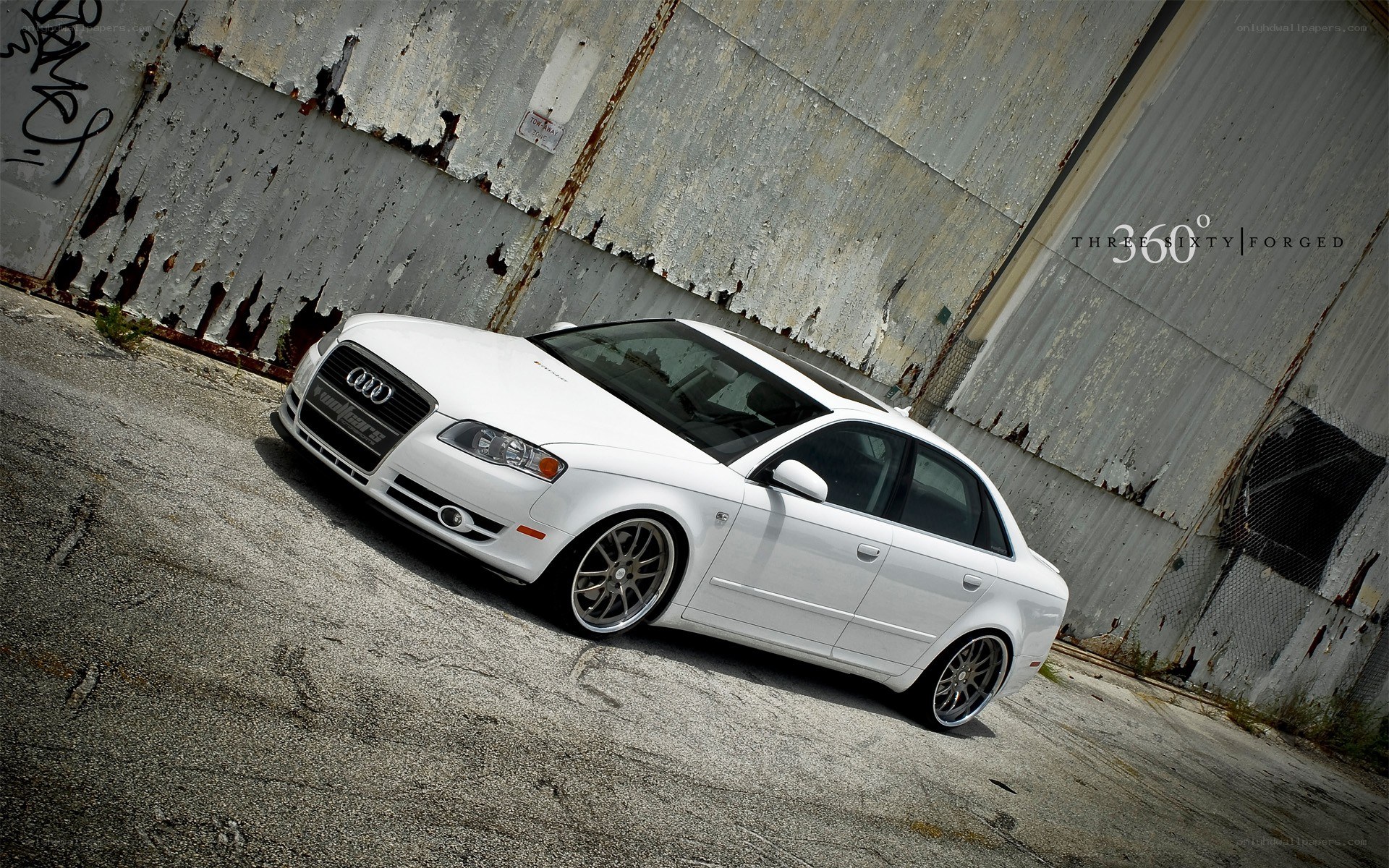 white audi sedan in urban setting