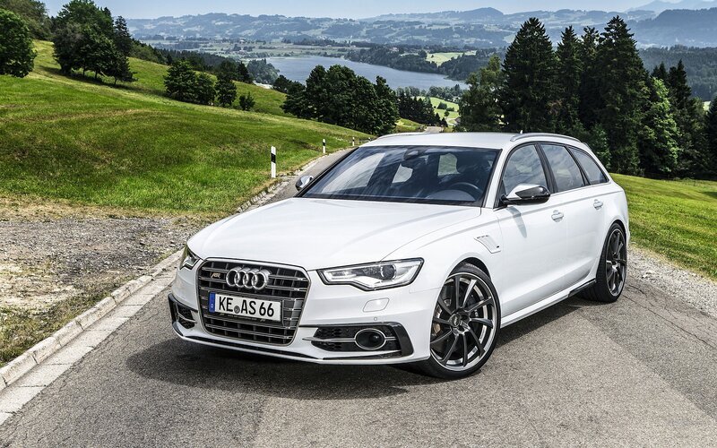 White Audi station wagon on a scenic road