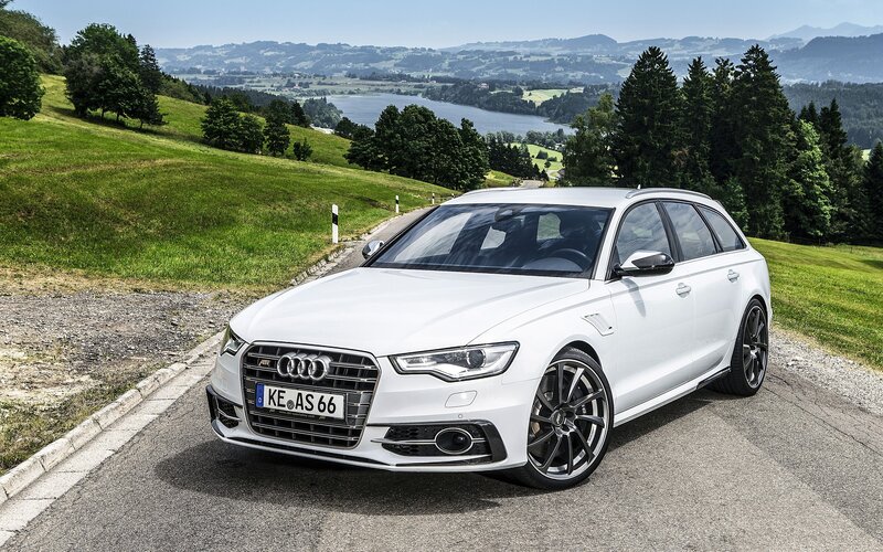 White Audi station wagon on a scenic road