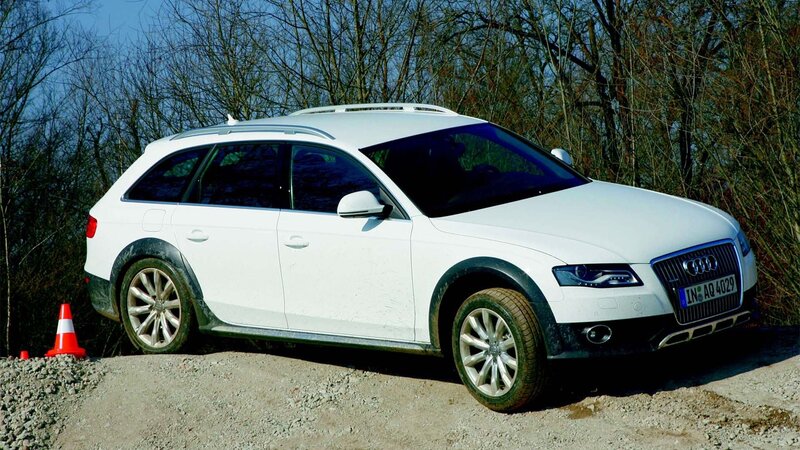 White Audi station wagon on gravel