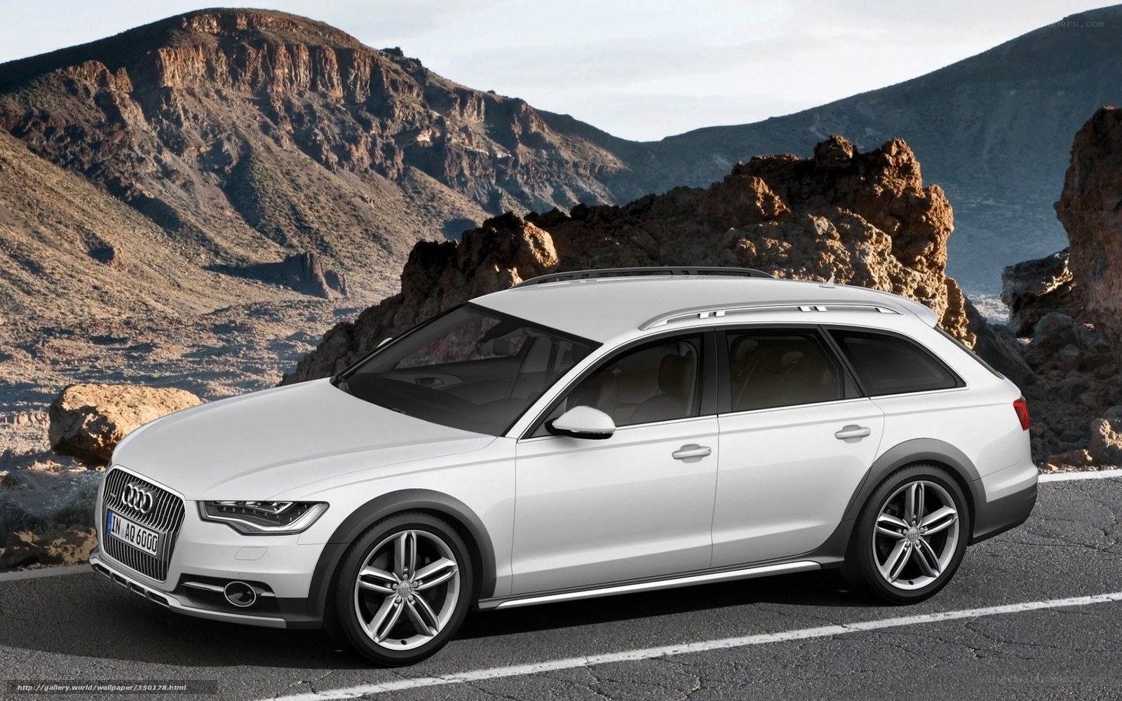 White Audi station wagon on mountain road