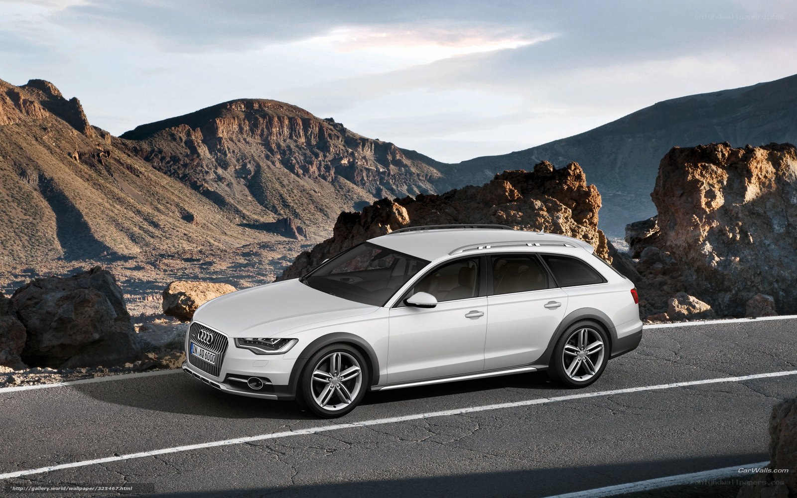 White Audi station wagon on mountain road