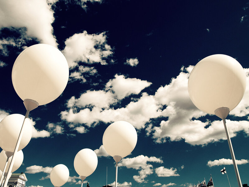 White balloons against blue sky