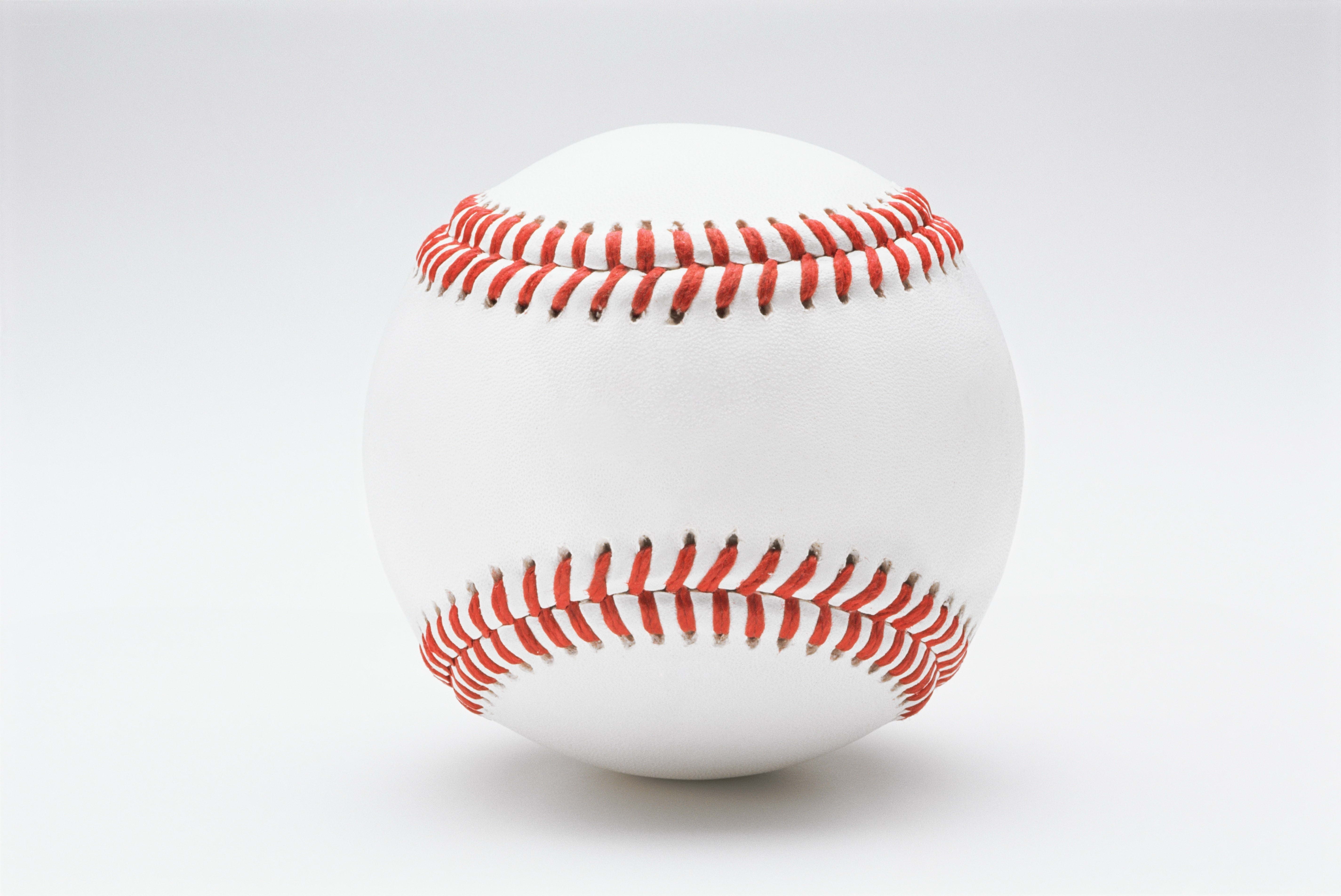 white baseball with red stitching