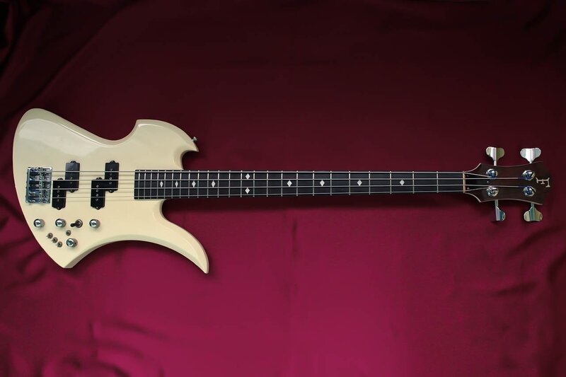 white bass guitar on red cloth