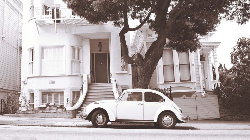 White Beetle in front of a house