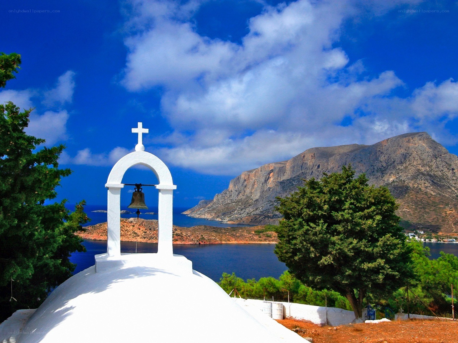 White bell tower by the sea