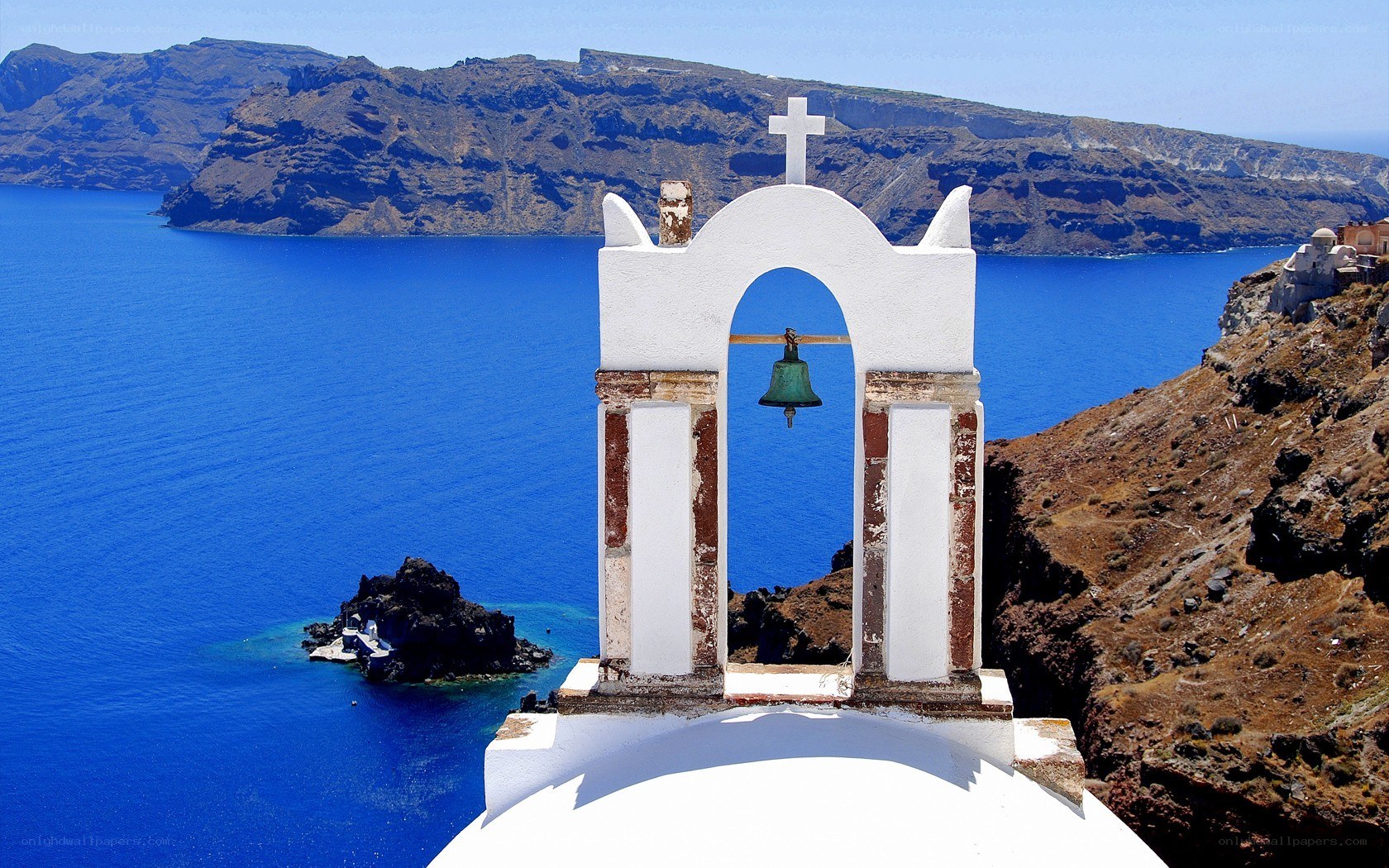 White bell tower overlooking the sea