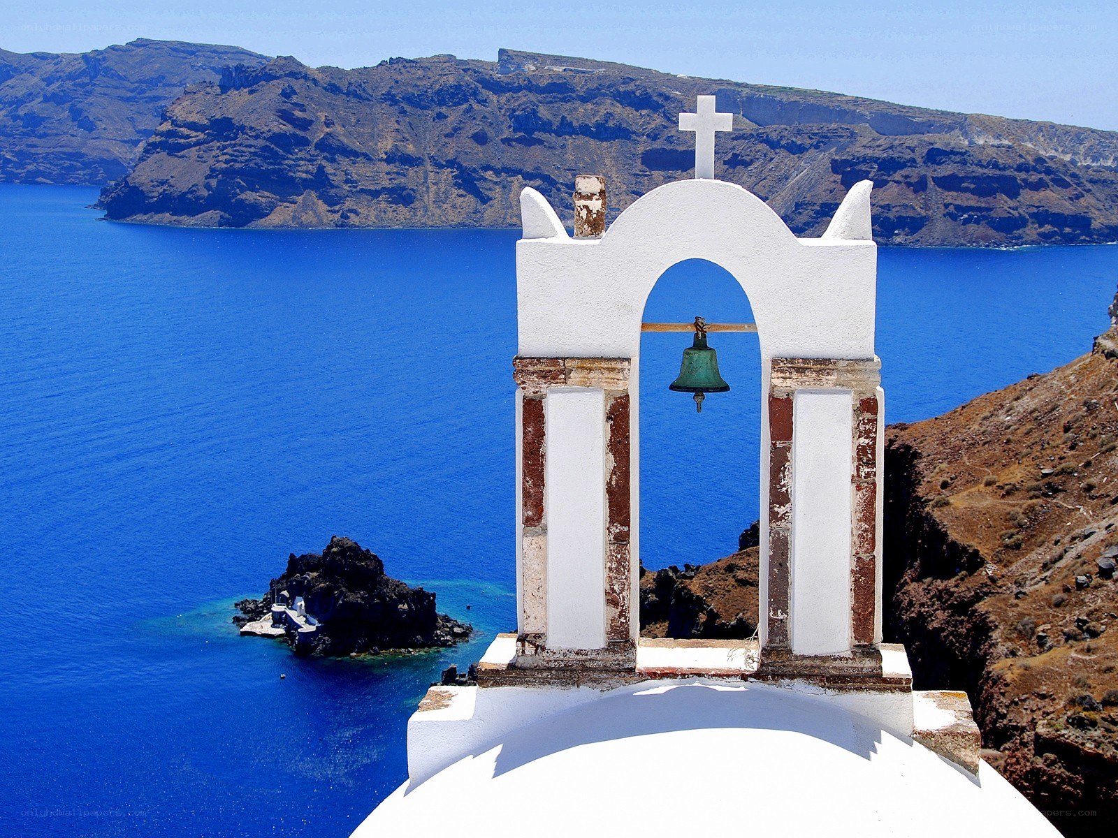 White bell tower overlooking the sea