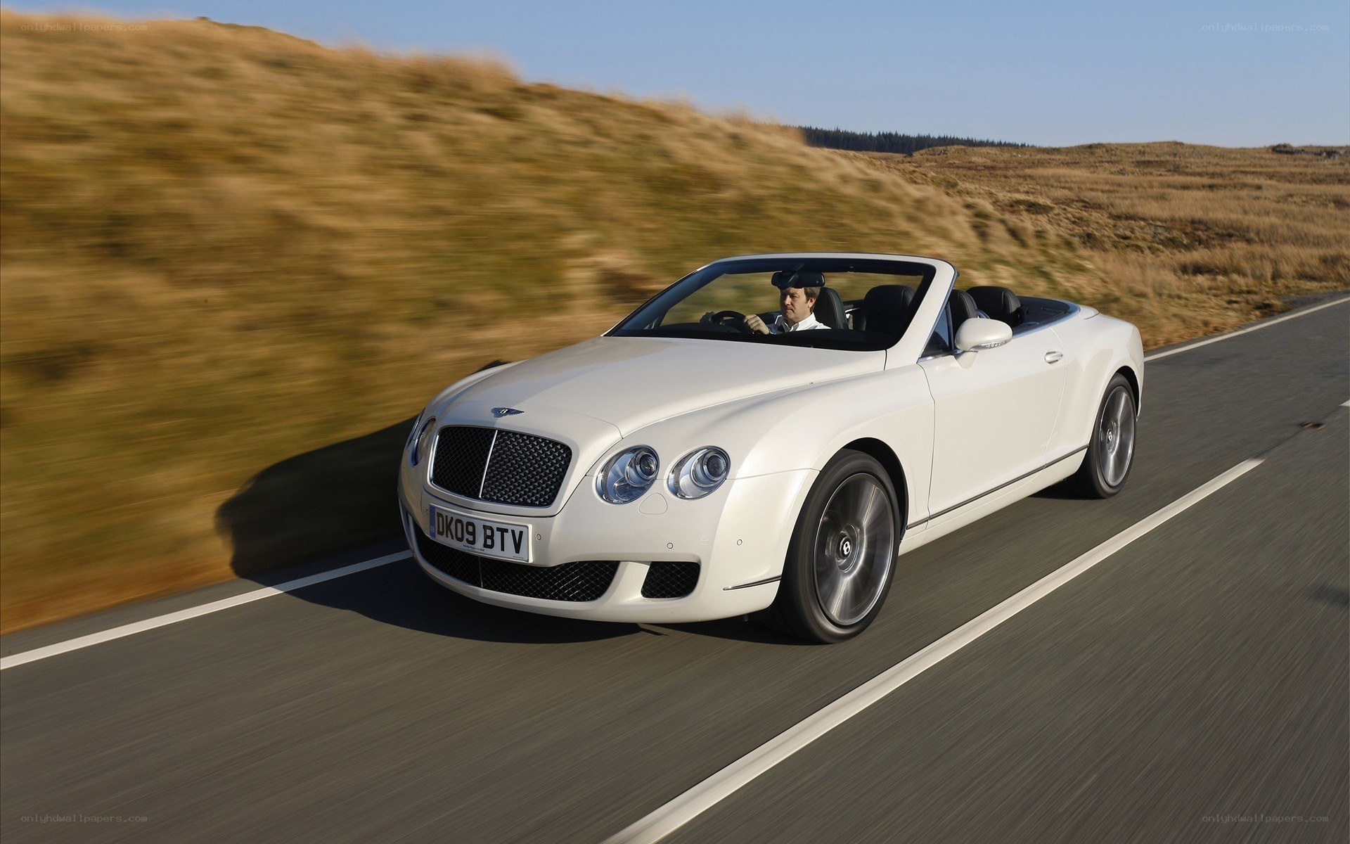 White Bentley convertible on road