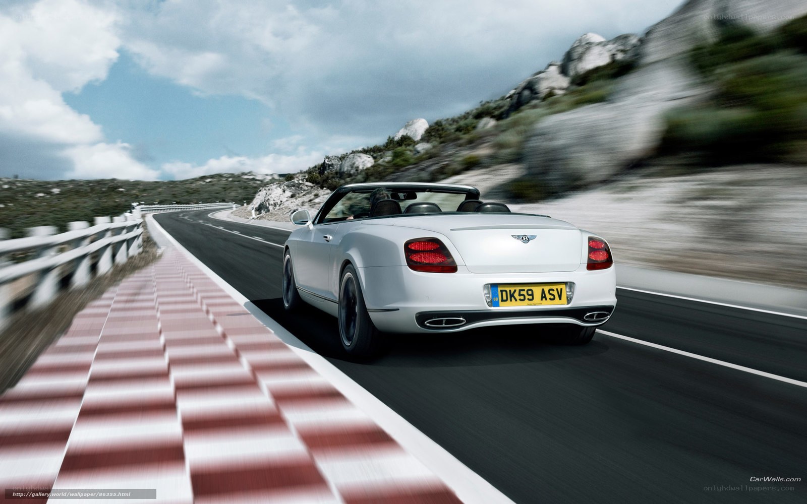 White Bentley convertible on winding road