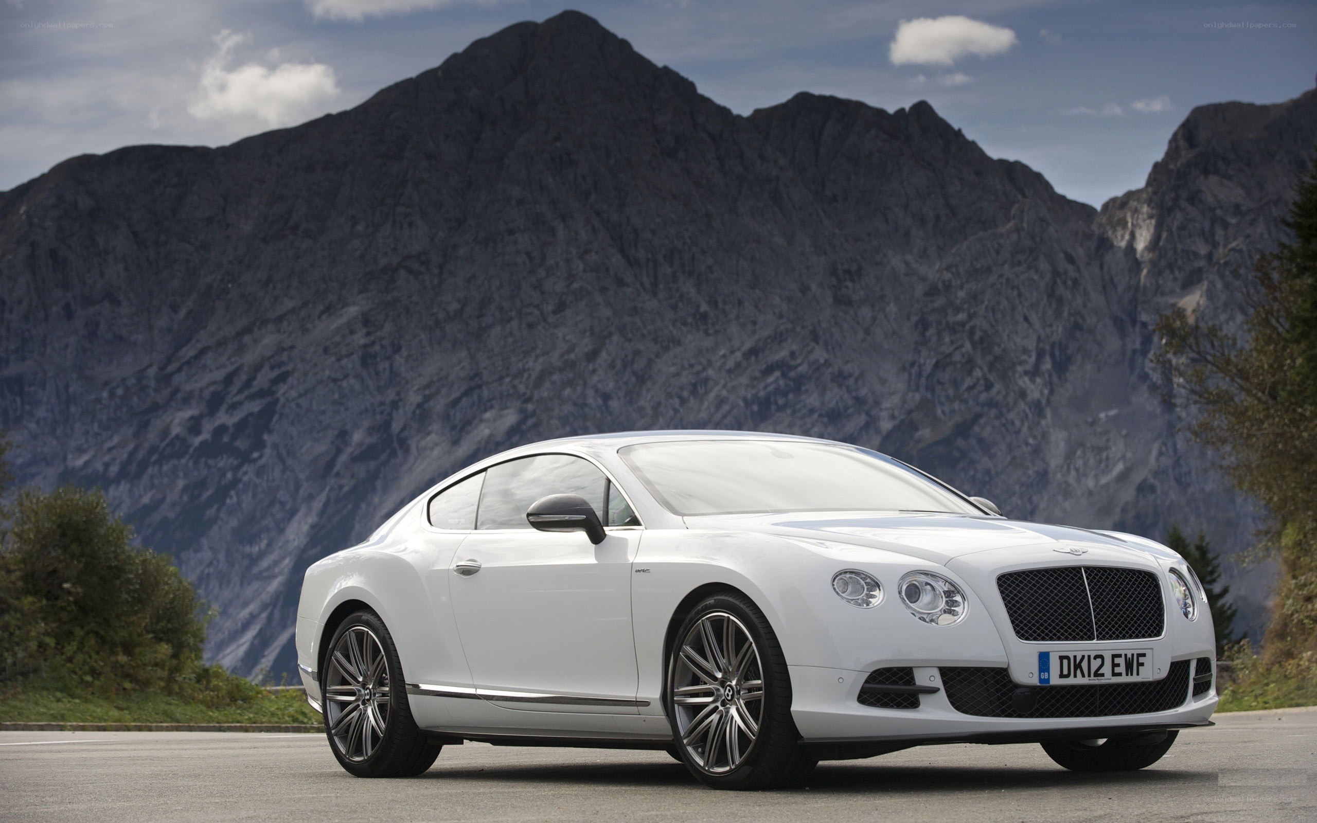 White Bentley coupe on mountain road