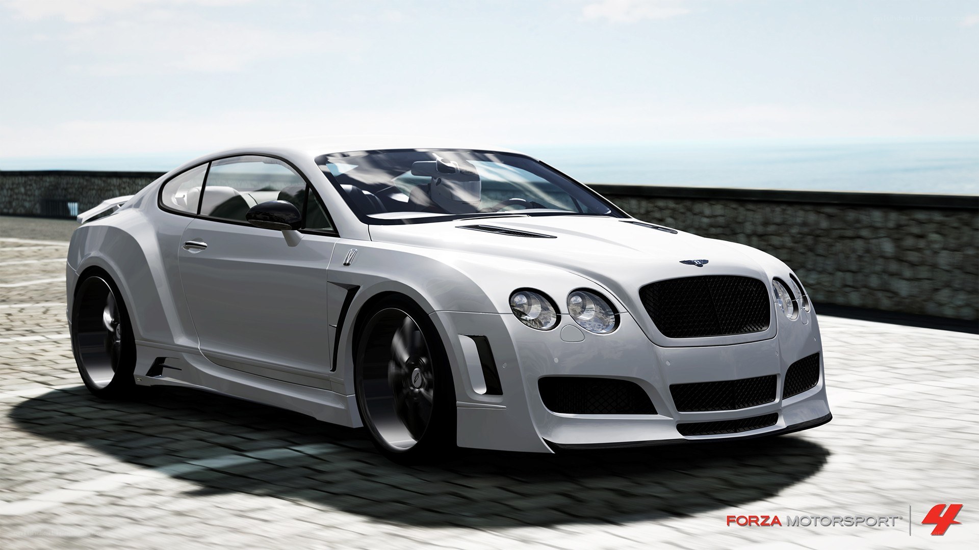 white bentley on coastal road