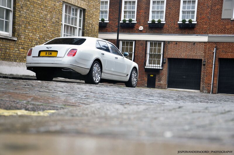 White Bentley on cobblestone street