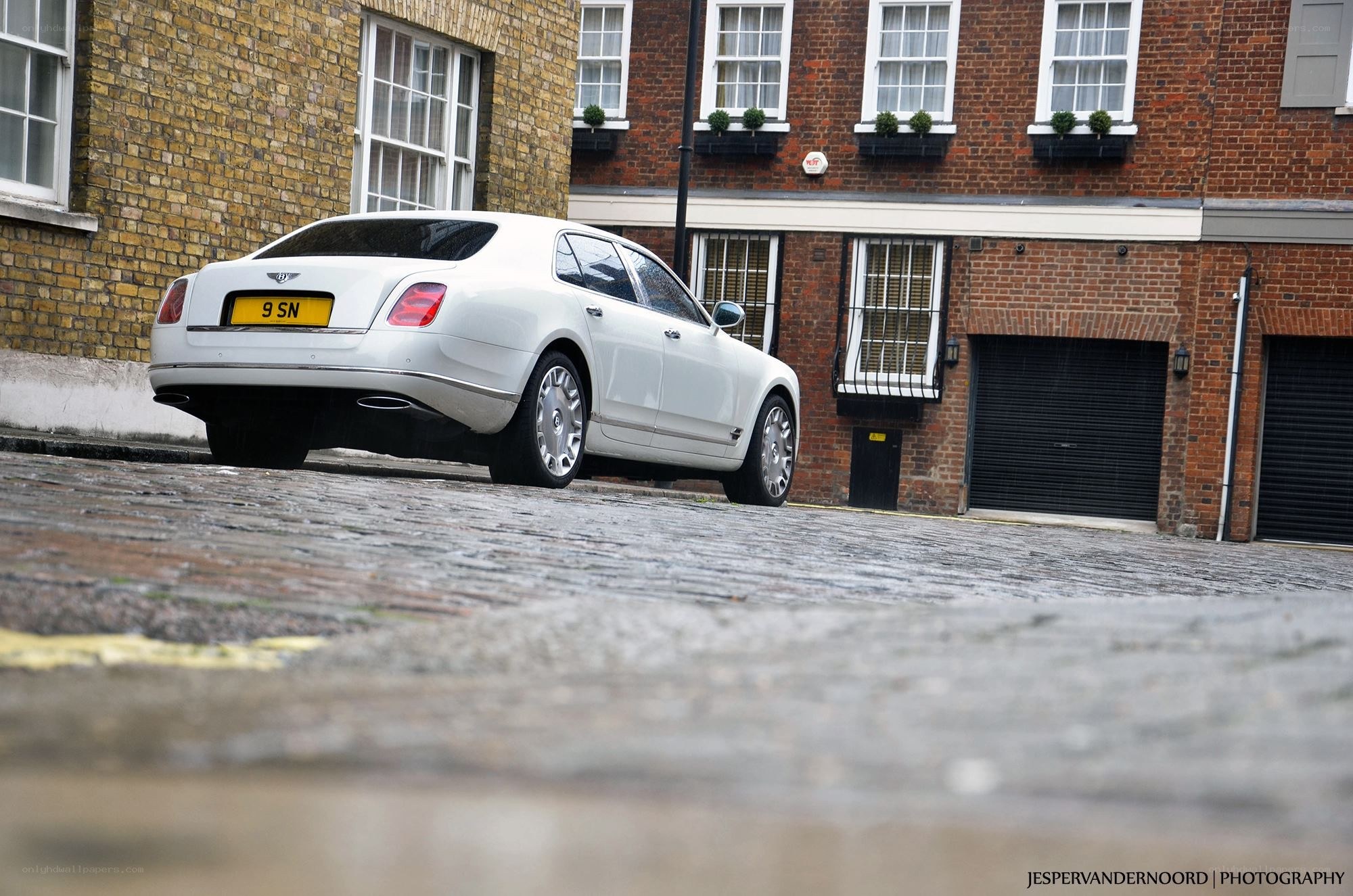 White Bentley on cobblestone street