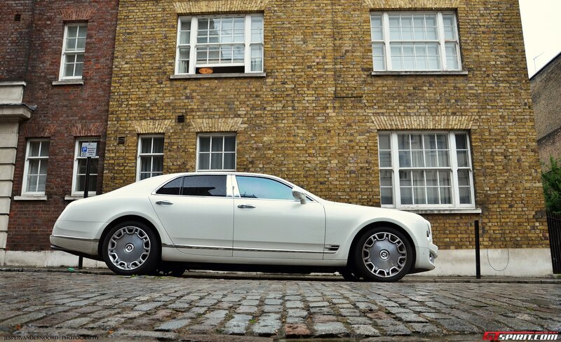 white bentley parked on cobblestones