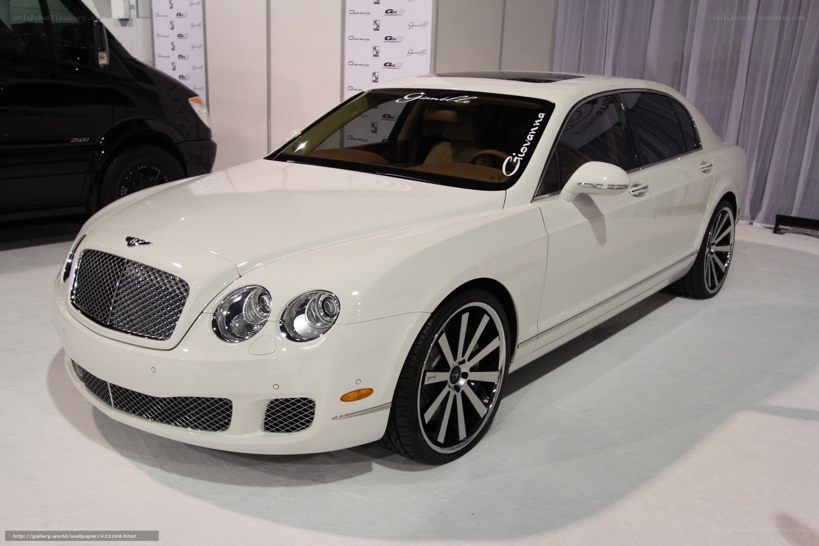 white bentley sedan on display