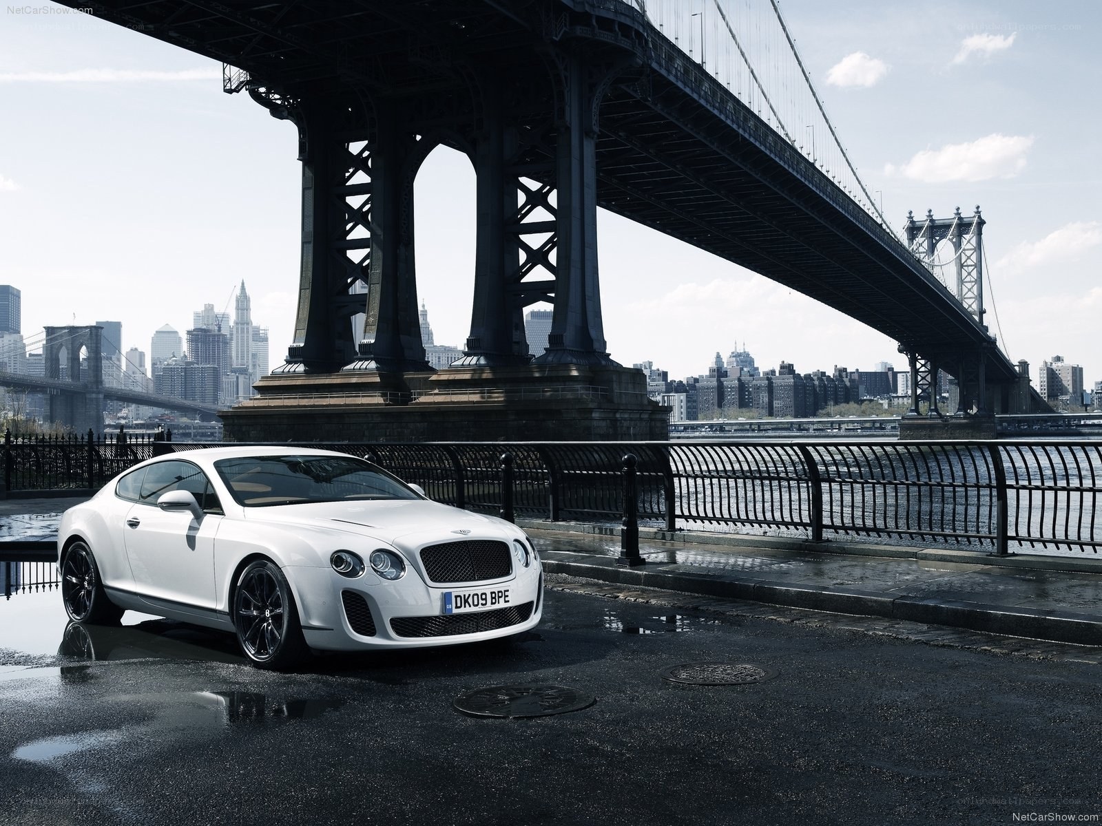 White Bentley under a bridge