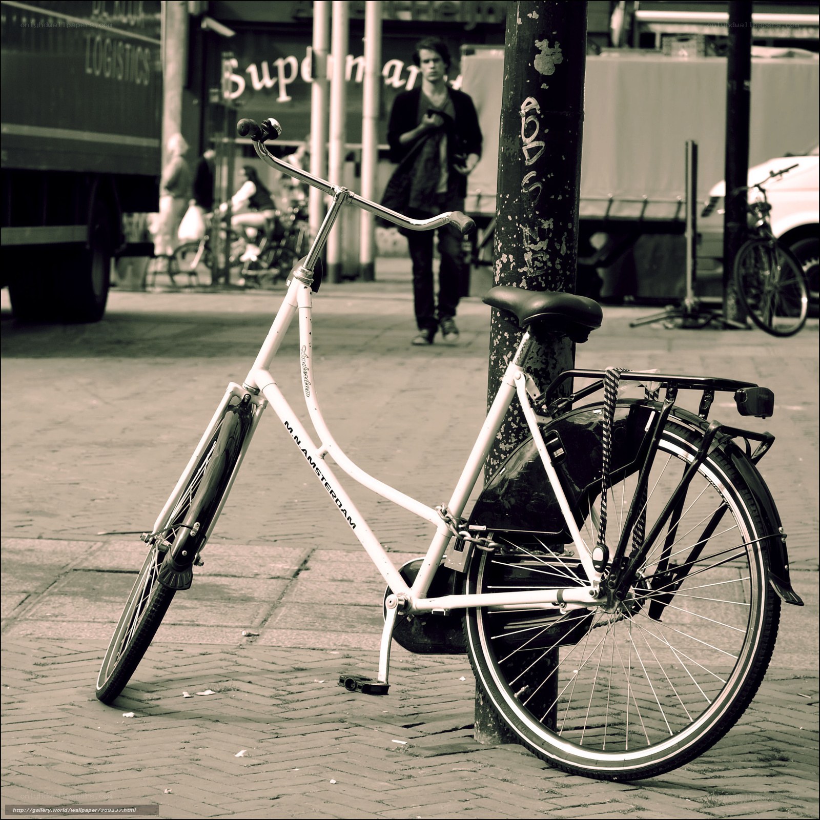 White bicycle parked on sidewalk