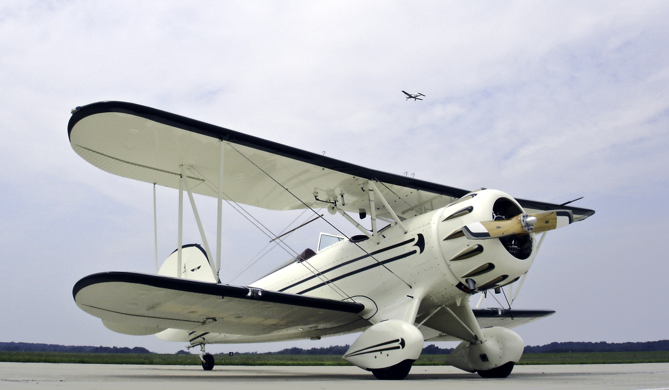 white biplane on tarmac