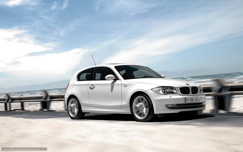White BMW 1 Series on coastal road