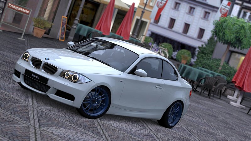White BMW 135i on cobblestone street
