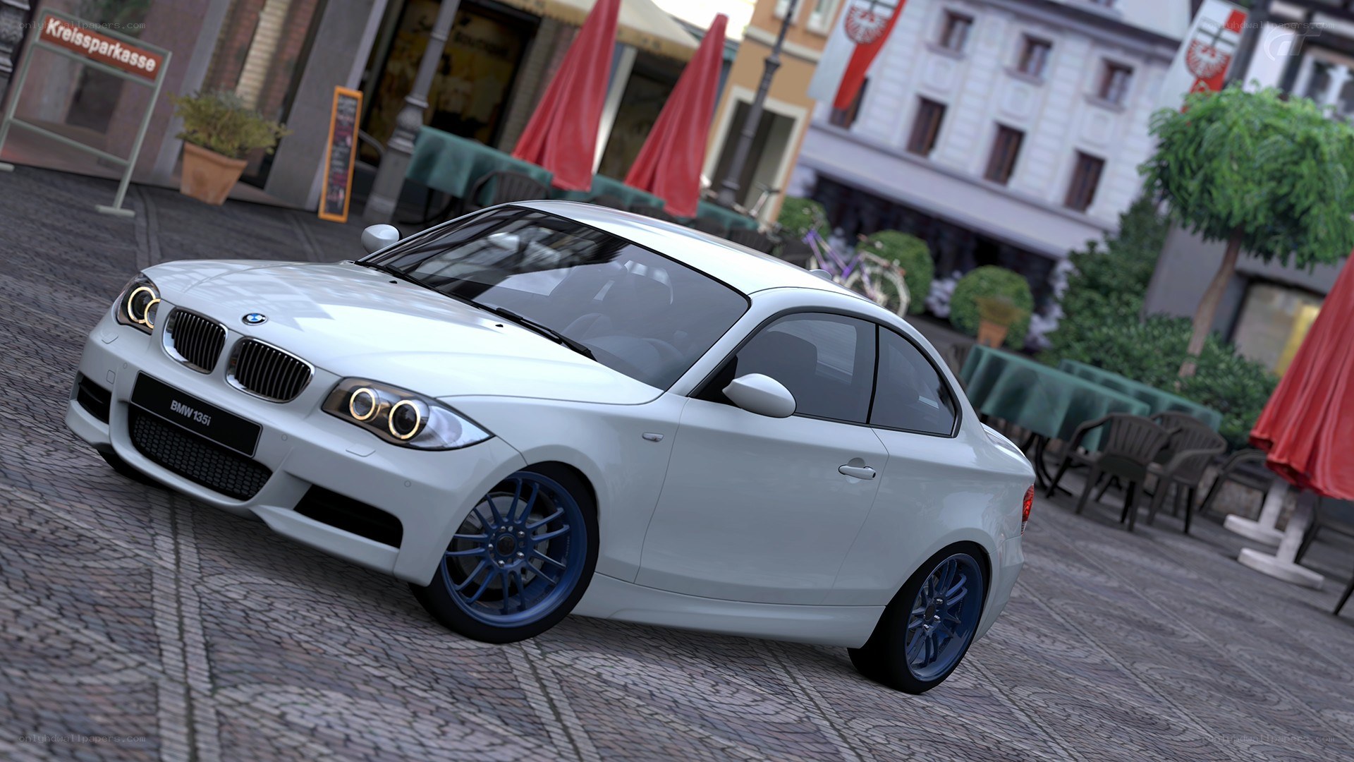 White BMW 135i on cobblestone street