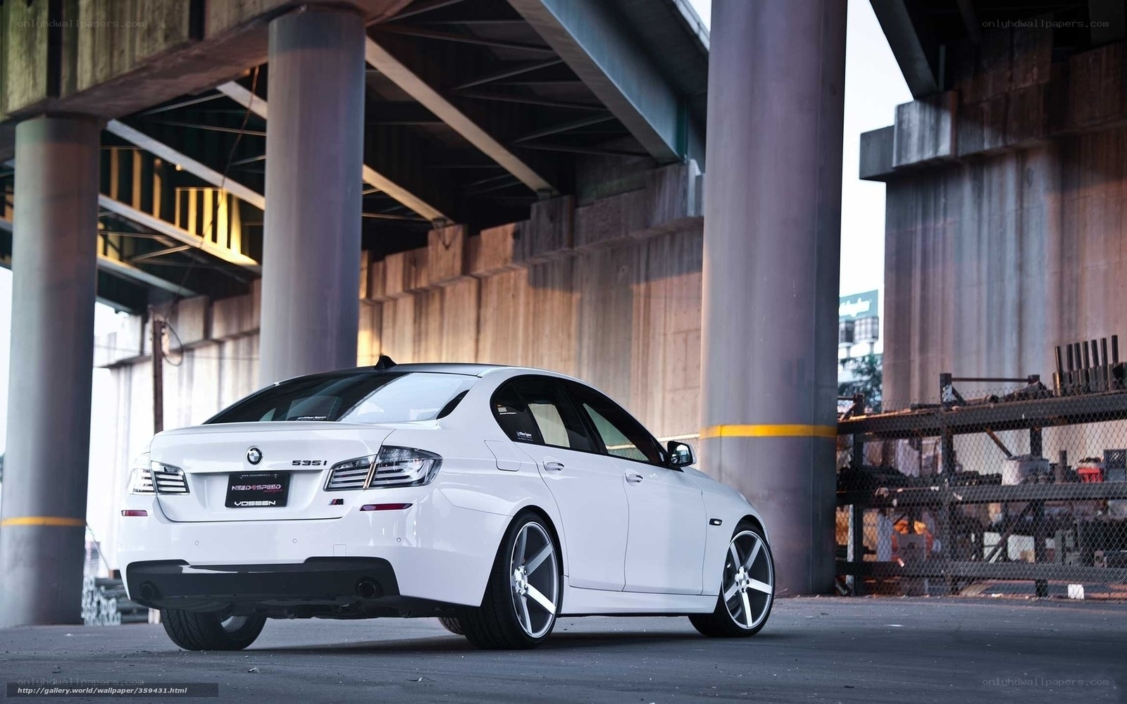 white bmw 535i under overpass