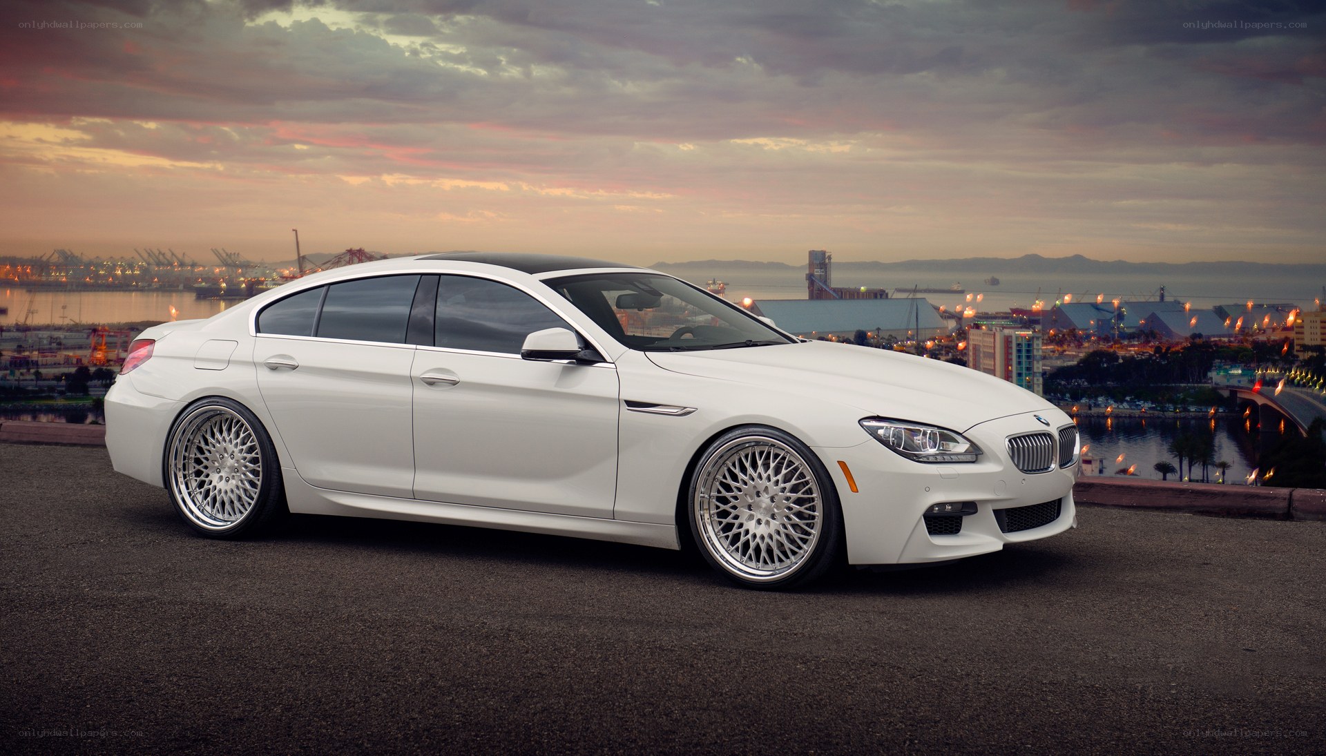 White BMW 6 Series at sunset