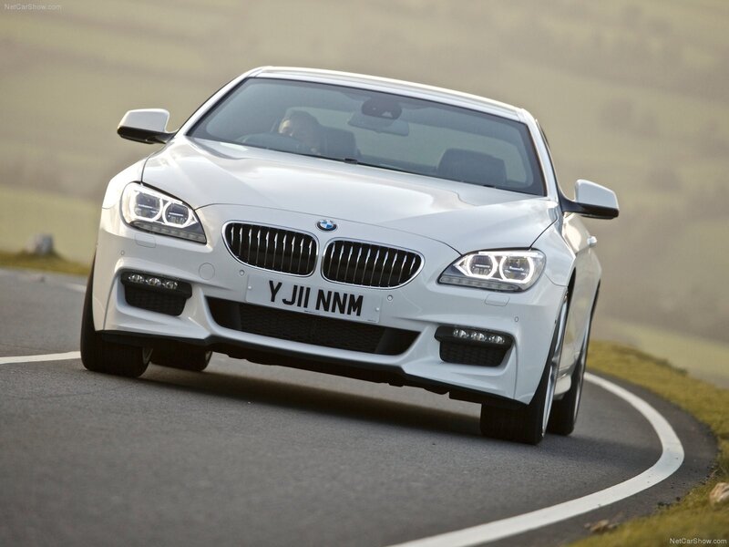 White BMW 6-Series driving on road