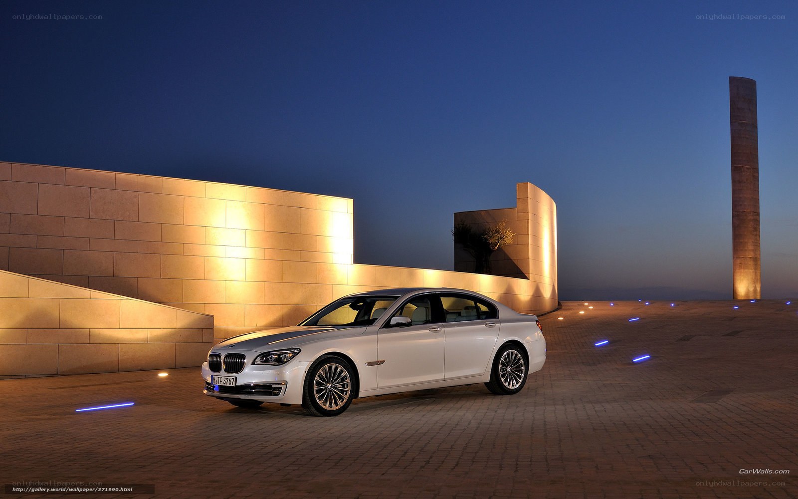 White BMW 7 Series at dusk