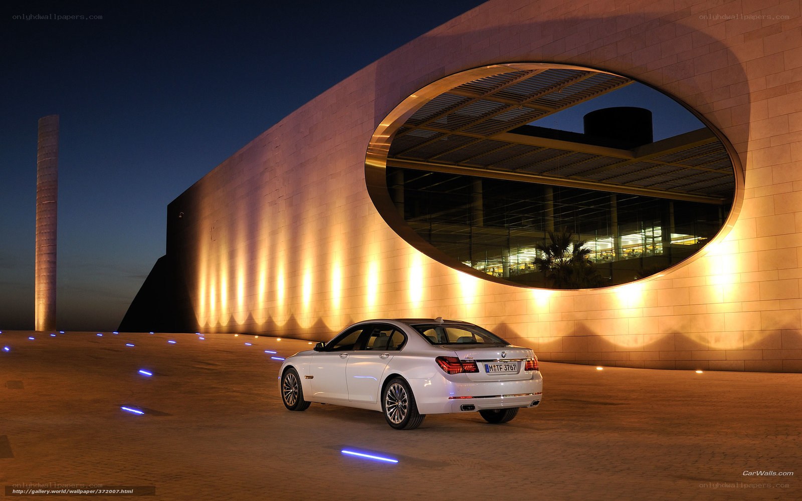 White BMW 7 Series at night