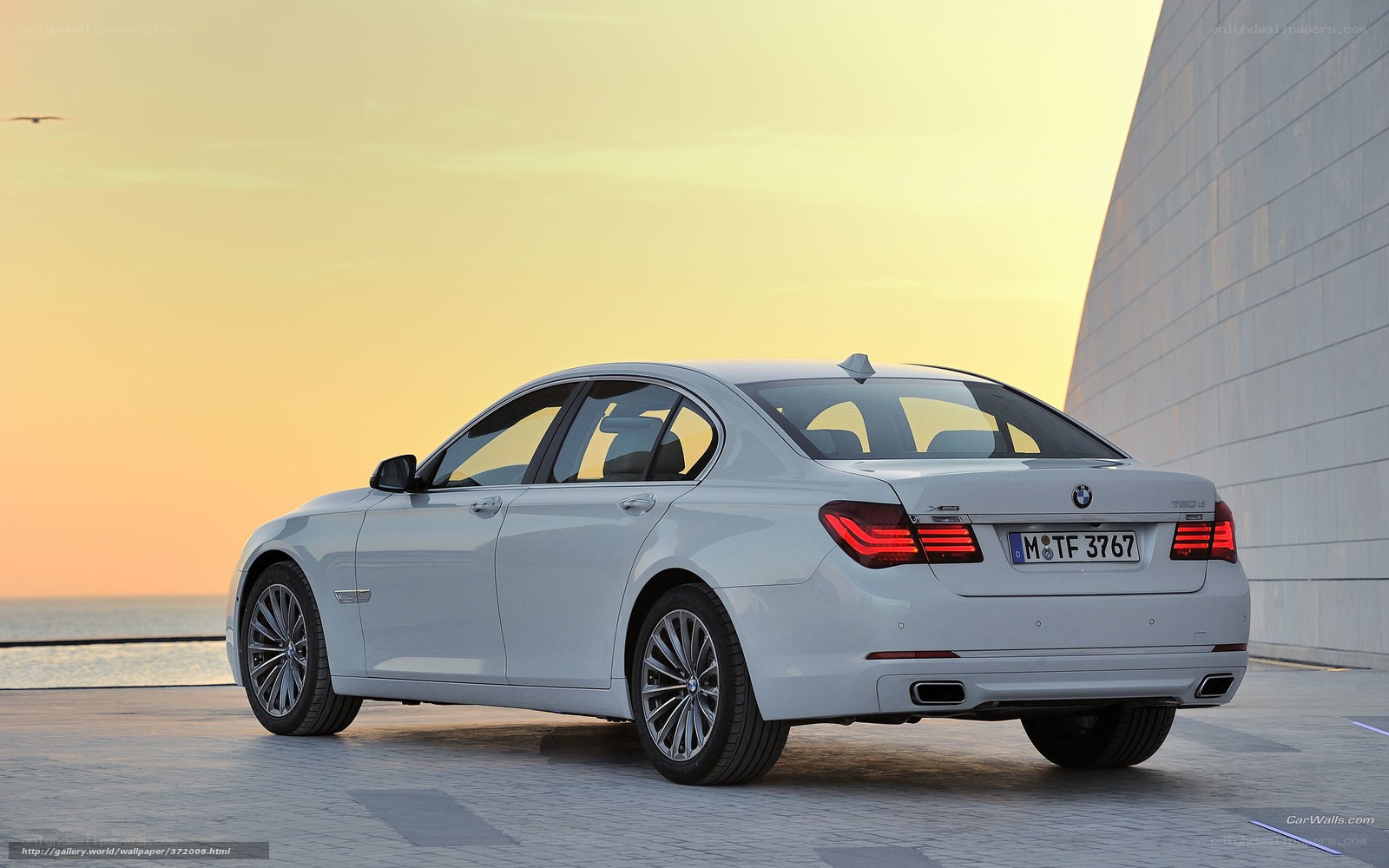 White BMW 7-Series at sunset