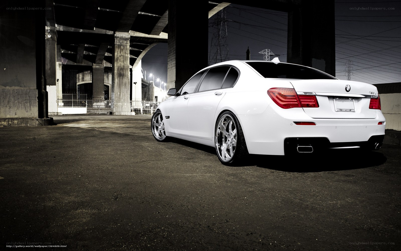 White BMW 7 Series under bridge