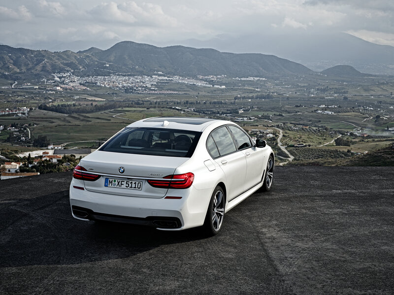 White BMW 750i on a mountain overlook