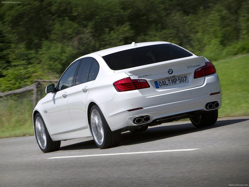white bmw alpina driving on road