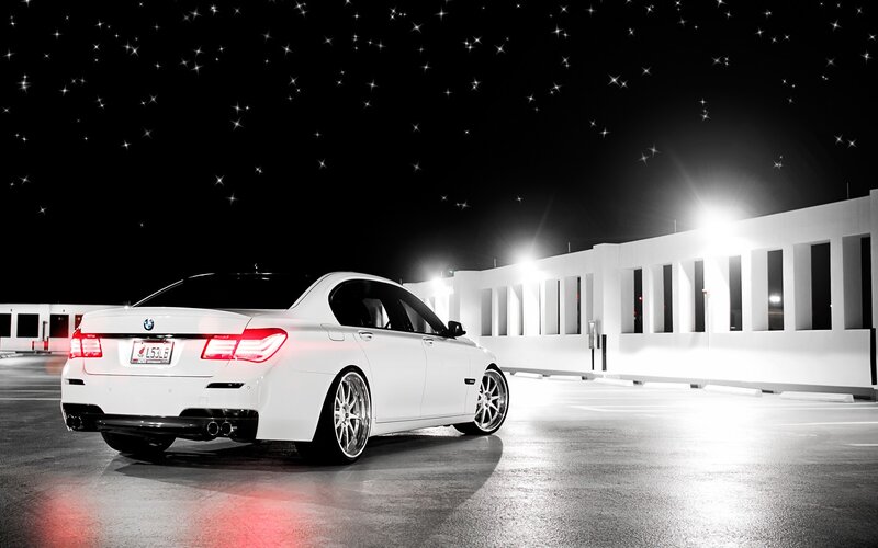White BMW at night with stars