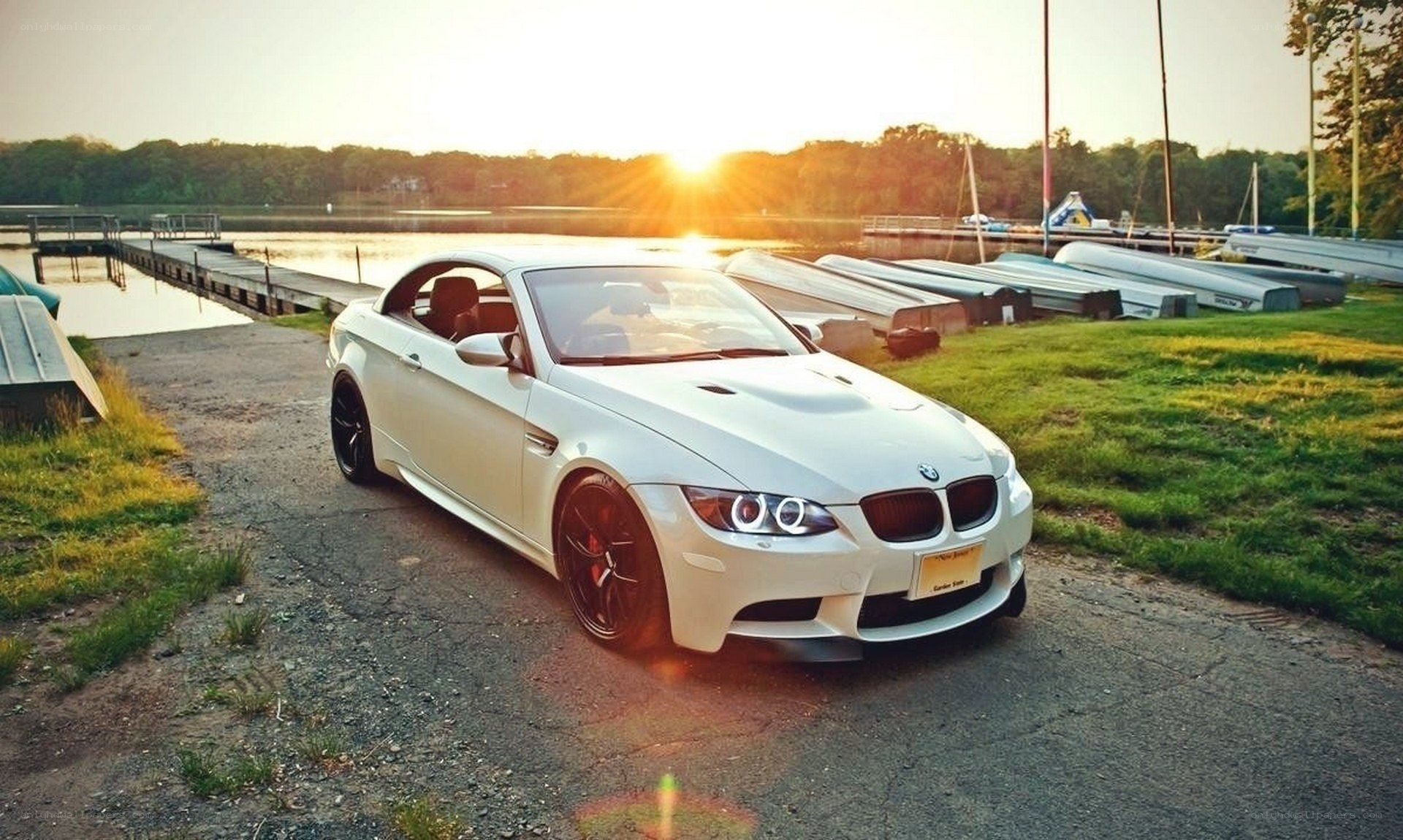 White BMW at sunset by the lake