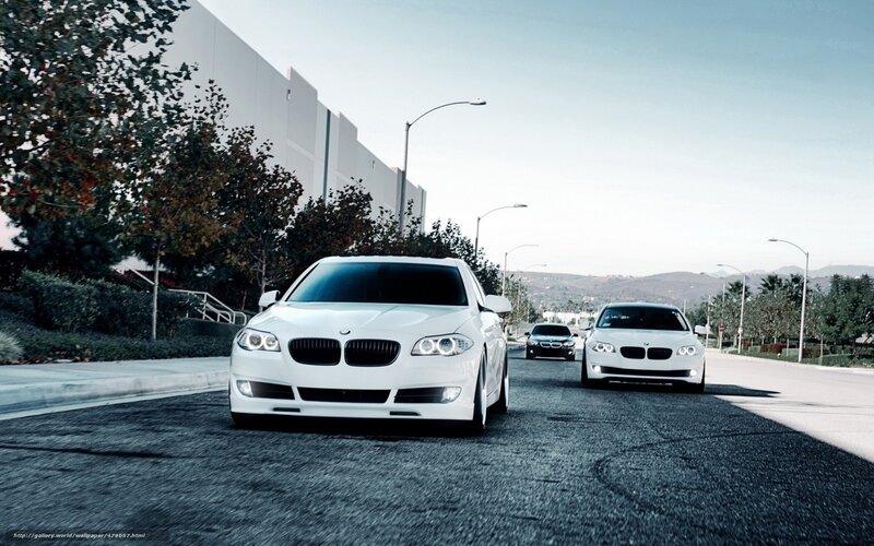 White BMW cars on a road