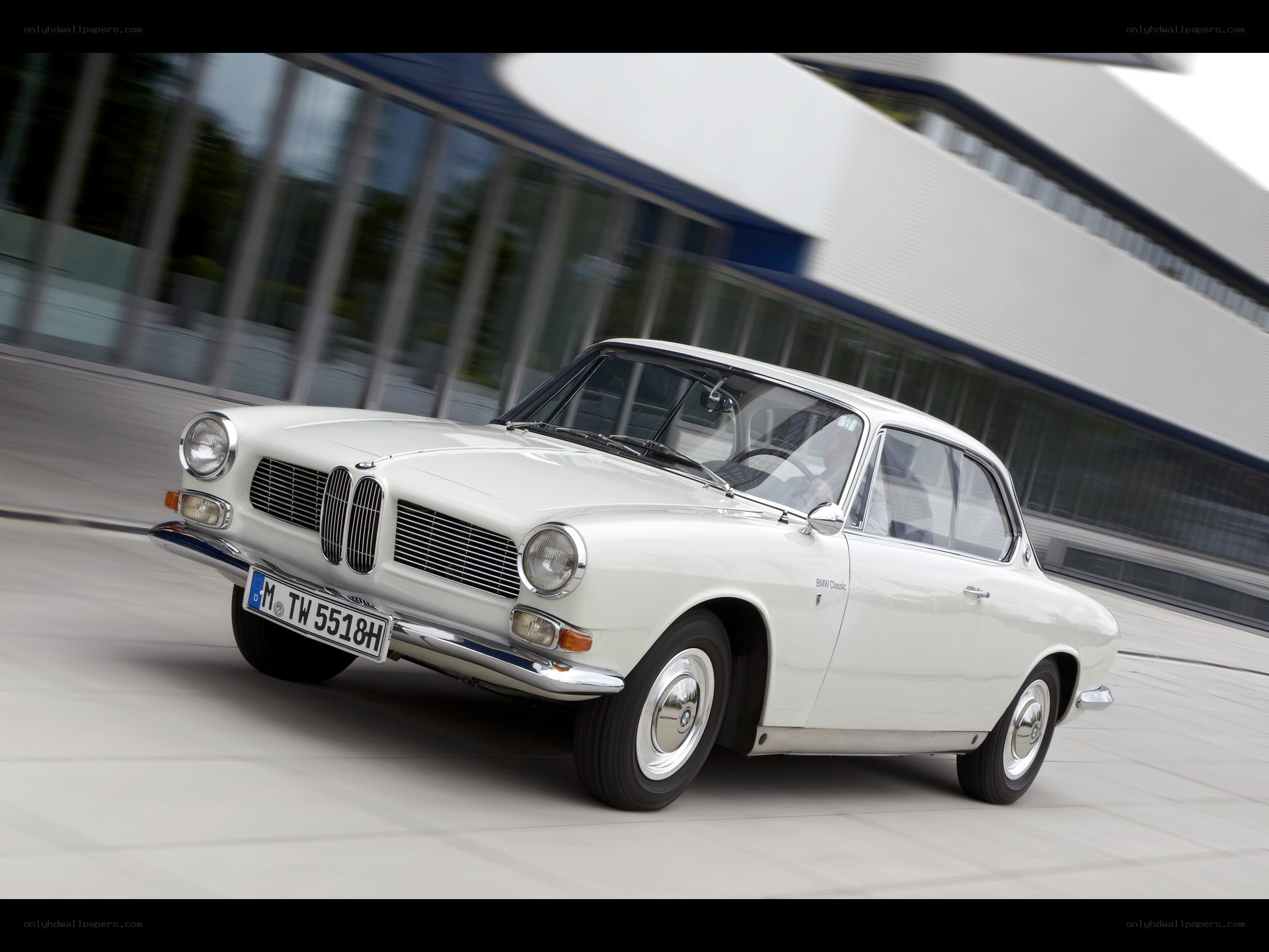 White BMW classic car in motion