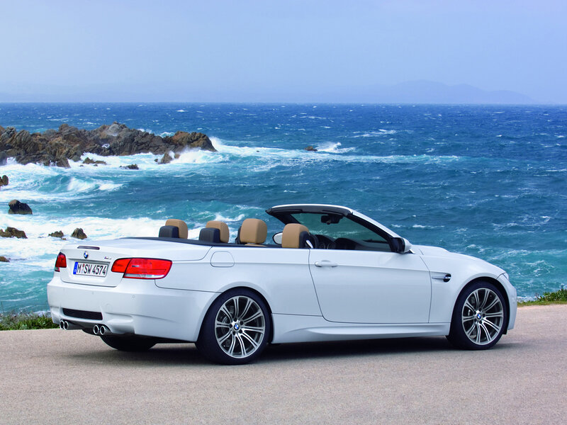 White BMW convertible by the sea