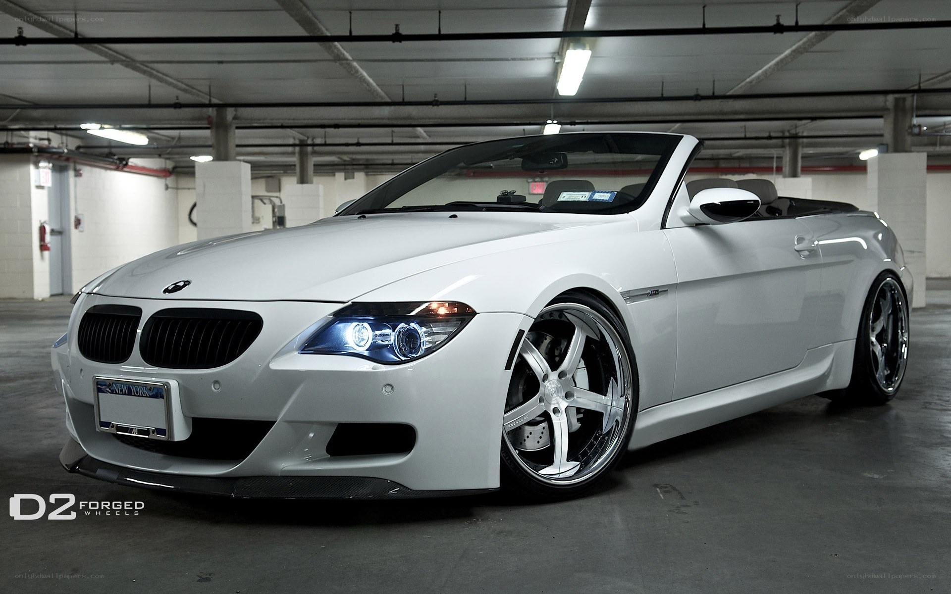 white bmw convertible in garage