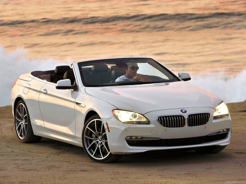 White BMW convertible on beach