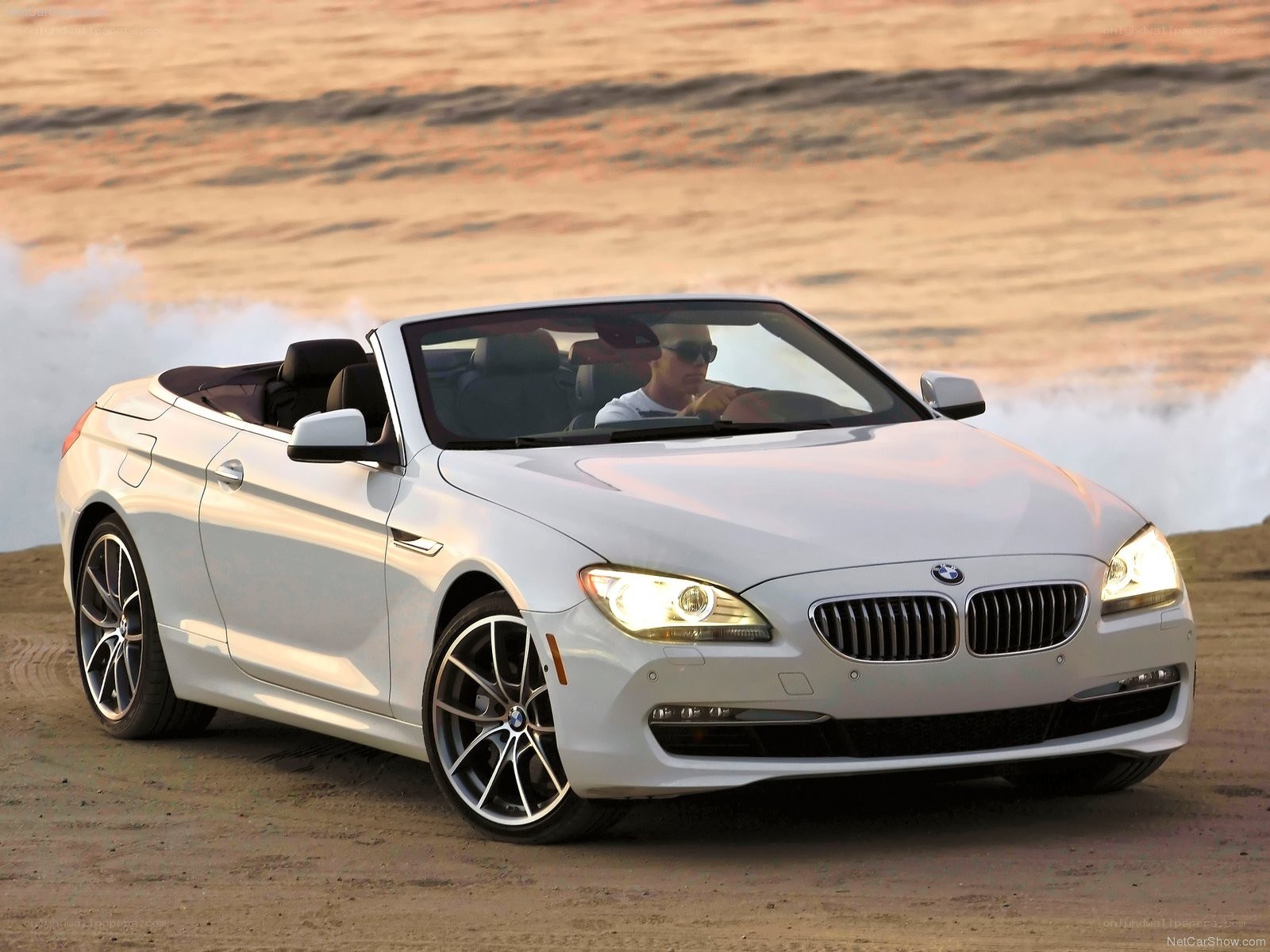 White BMW convertible on beach