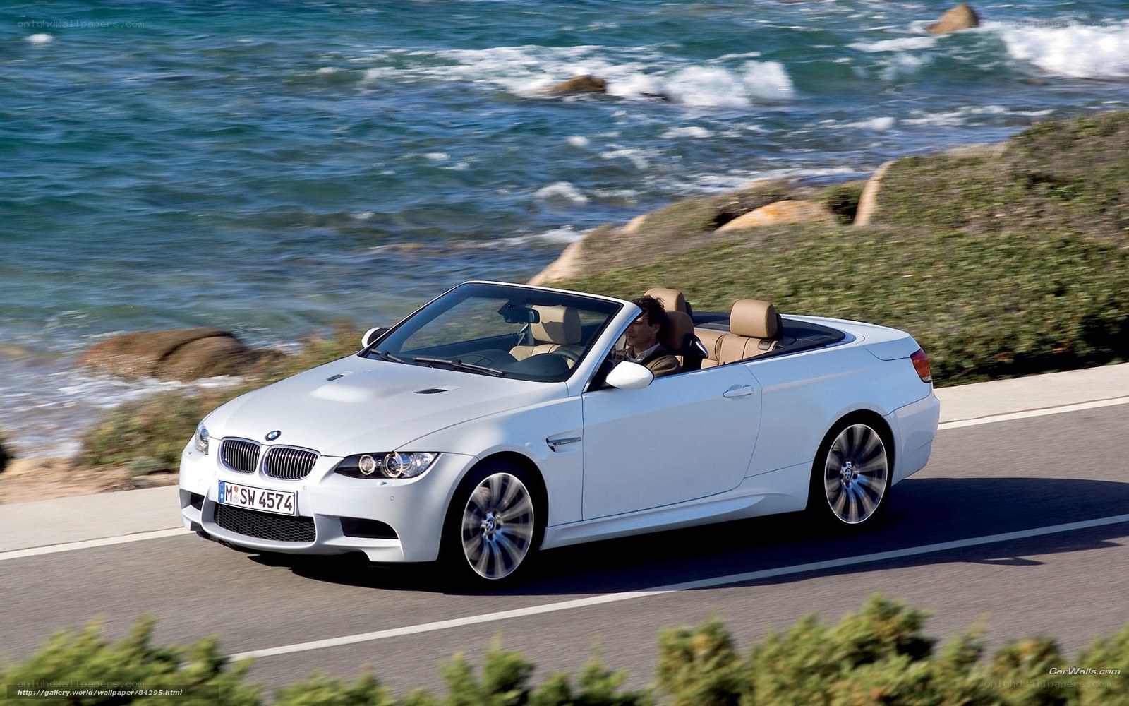 White BMW convertible on coastal road