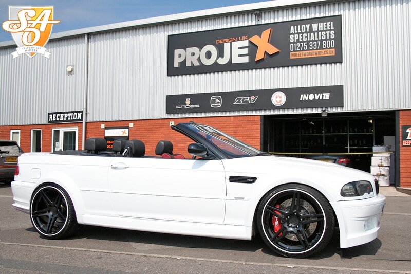 White BMW convertible outside wheel shop